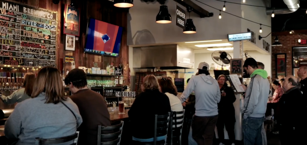 Group of people sitting together to enjoy beer at Little Miami in Cincinnati